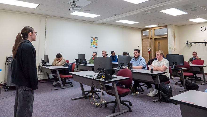 A female student making a presentation in front of a class