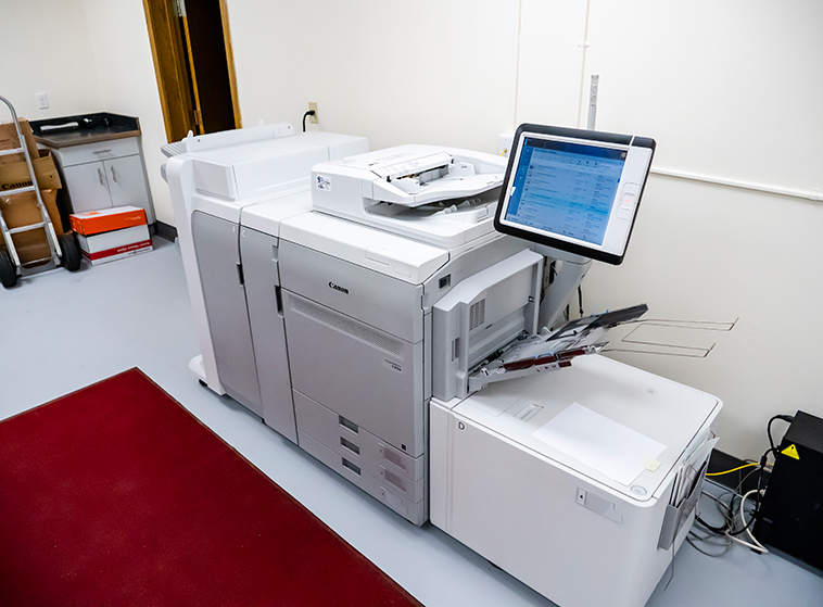NWC Campus Services: Mail & Printing Overhead view of a large copy machine with display screen